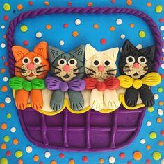 Пін може містити: there are five cats sitting in a basket on the cake, and one cat is wearing a bow tie