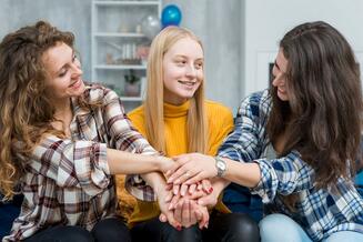 Friends with their hands together