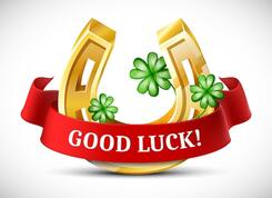 Vector cartoon style golden horseshoe with clover leaves and good luck red ribbon