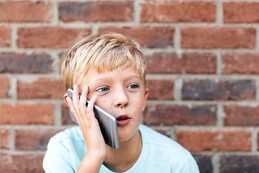 Expressive Boy Talking On A Phone" by Stocksy Contributor "Kelly Knox" - Stocksy