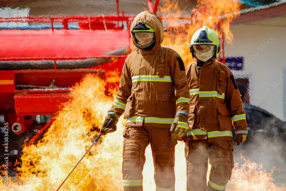firefighter training., fireman using water and extinguisher to fighting with fire flame in an emergency situation., under danger situation all firemen wearing fire fighter suit for safety. Stock Photo | Adobe Stock