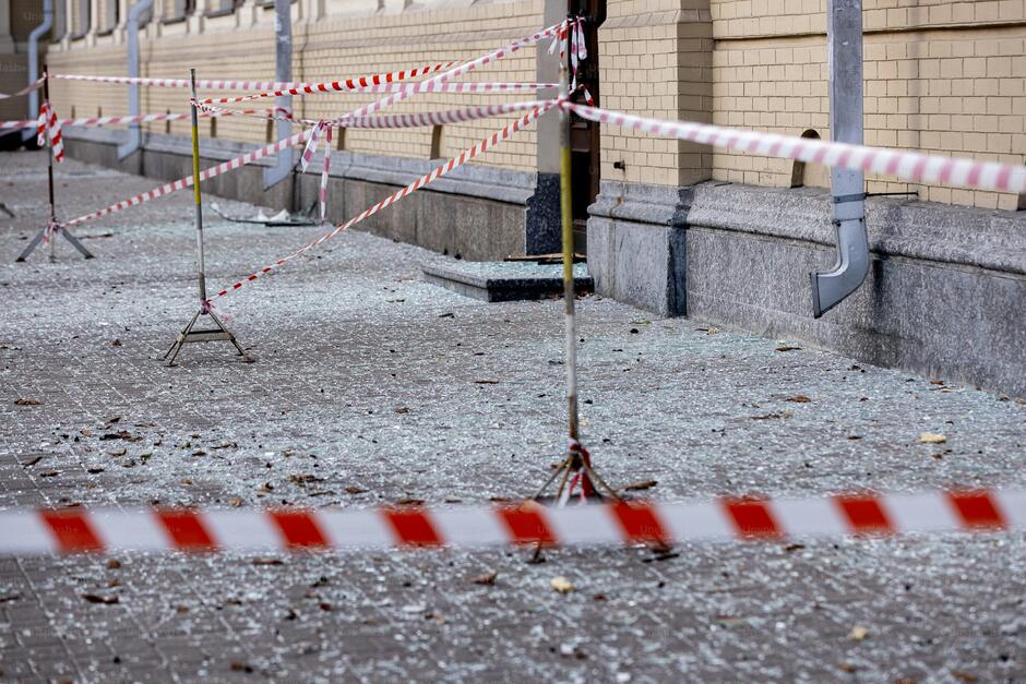 there is a red and white caution tape on the ground